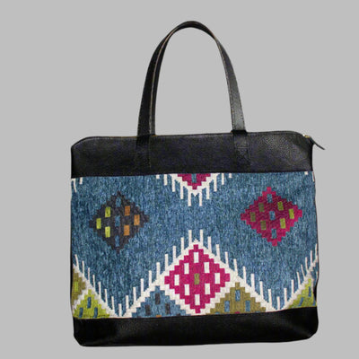 Weekend Kilim Genuine Leather Bag XL size is Handcrafted in Old Cairo, Egypt, This bag is one of a kind masterpiece, made from vintage fabrics and genuine leather to embody the essence of sustainable luxury.a gift to the world of Ancient craftsmanship meeting modern functionality. A statement of creativity, cultural awareness and limitless style.