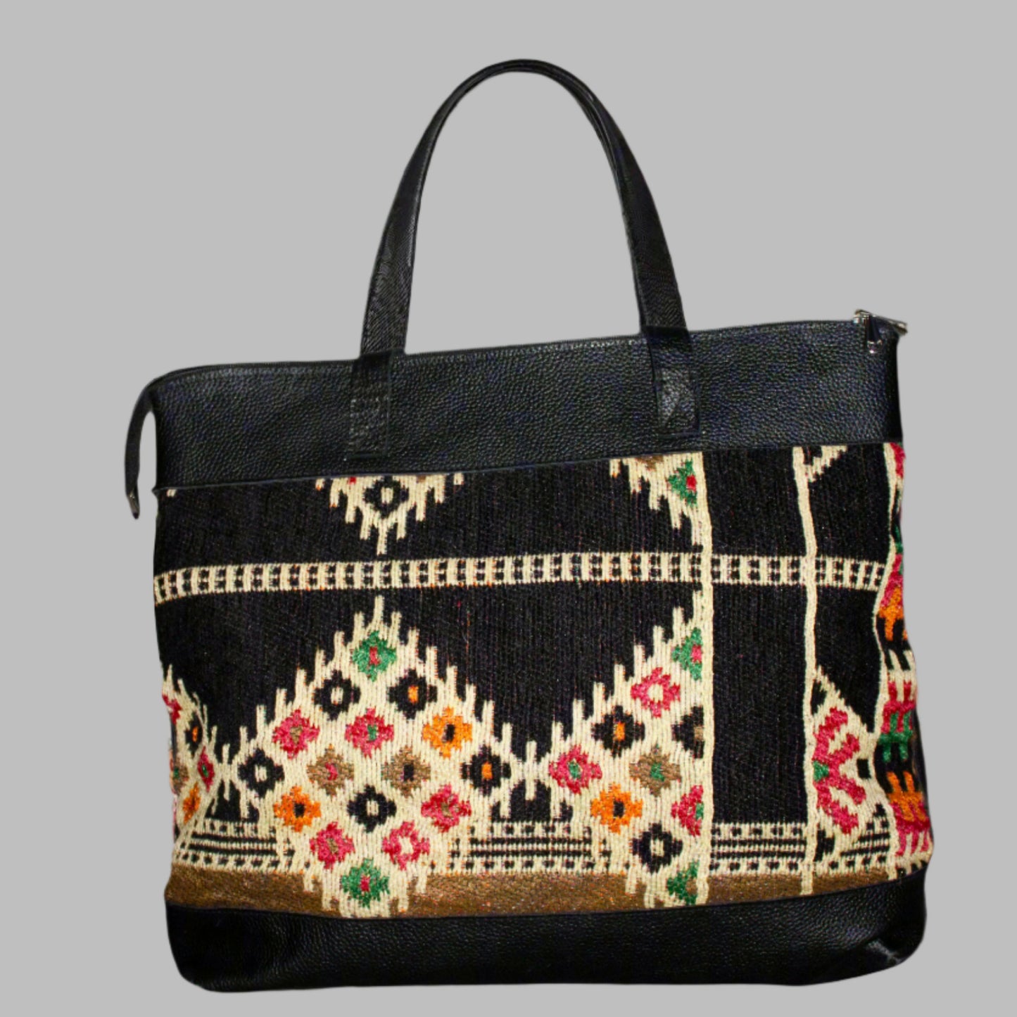 Weekend Kilim Genuine Leather Bag XL size is Handcrafted in Old Cairo, Egypt, This bag is one of a kind masterpiece, made from vintage fabrics and genuine leather to embody the essence of sustainable luxury.a gift to the world of Ancient craftsmanship meeting modern functionality. A statement of creativity, cultural awareness and limitless style.