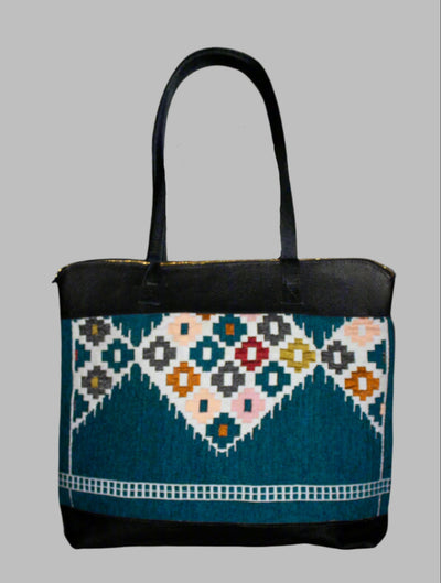 Weekend Kilim Genuine Leather Bag XL size is Handcrafted in Old Cairo, Egypt, This bag is one of a kind masterpiece, made from vintage fabrics and genuine leather to embody the essence of sustainable luxury.a gift to the world of Ancient craftsmanship meeting modern functionality. A statement of creativity, cultural awareness and limitless style.