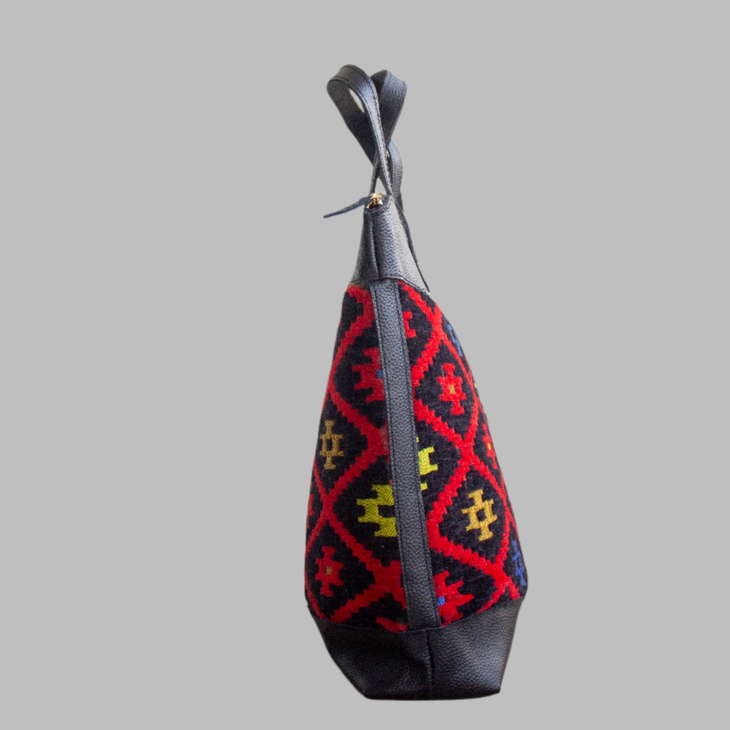 Weekend Kilim Genuine Leather Bag XL size is Handcrafted in Old Cairo, Egypt, This bag is one of a kind masterpiece, made from vintage fabrics and genuine leather to embody the essence of sustainable luxury.a gift to the world of Ancient craftsmanship meeting modern functionality. A statement of creativity, cultural awareness and limitless style.