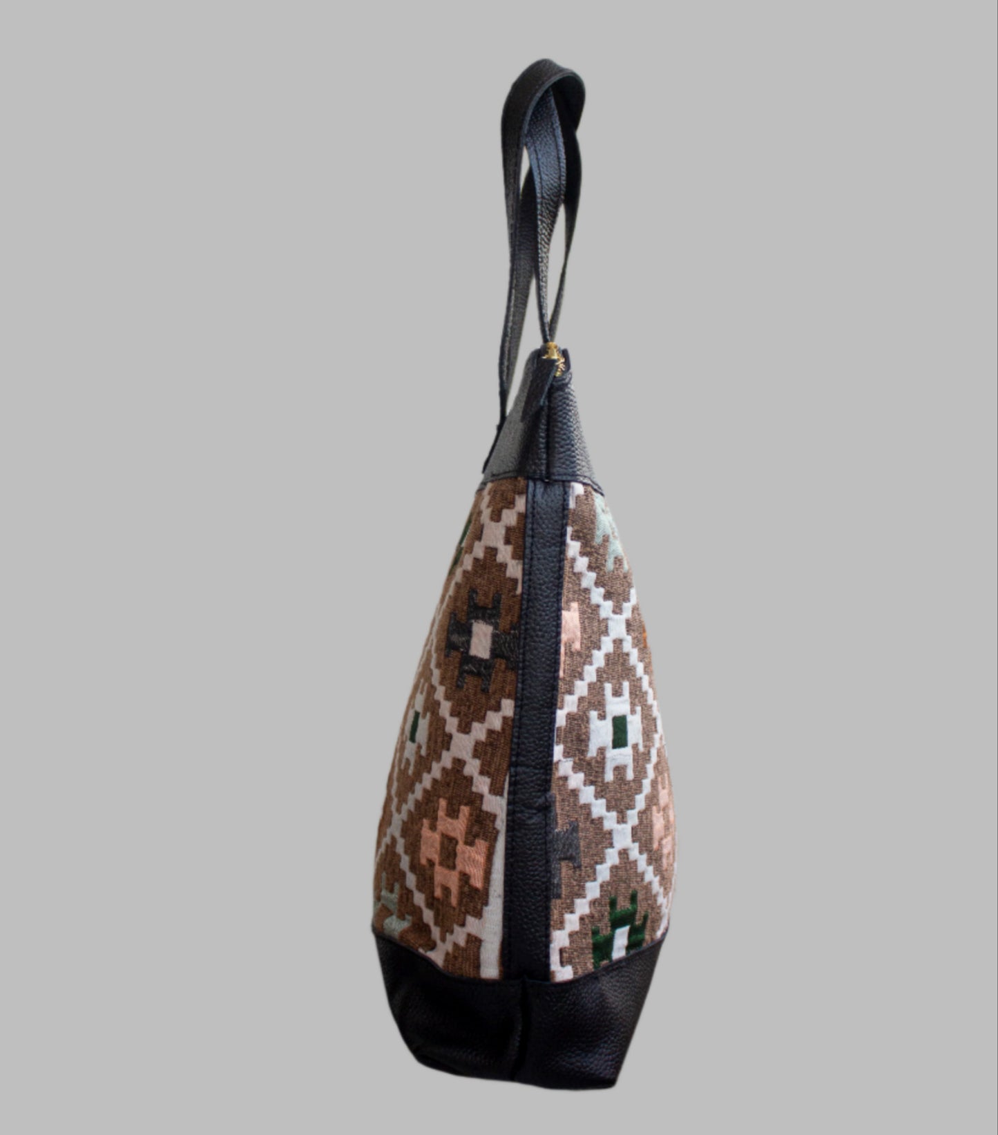 Weekend Kilim Genuine Leather Bag XL size is Handcrafted in Old Cairo, Egypt, This bag is one of a kind masterpiece, made from vintage fabrics and genuine leather to embody the essence of sustainable luxury.a gift to the world of Ancient craftsmanship meeting modern functionality. A statement of creativity, cultural awareness and limitless style.