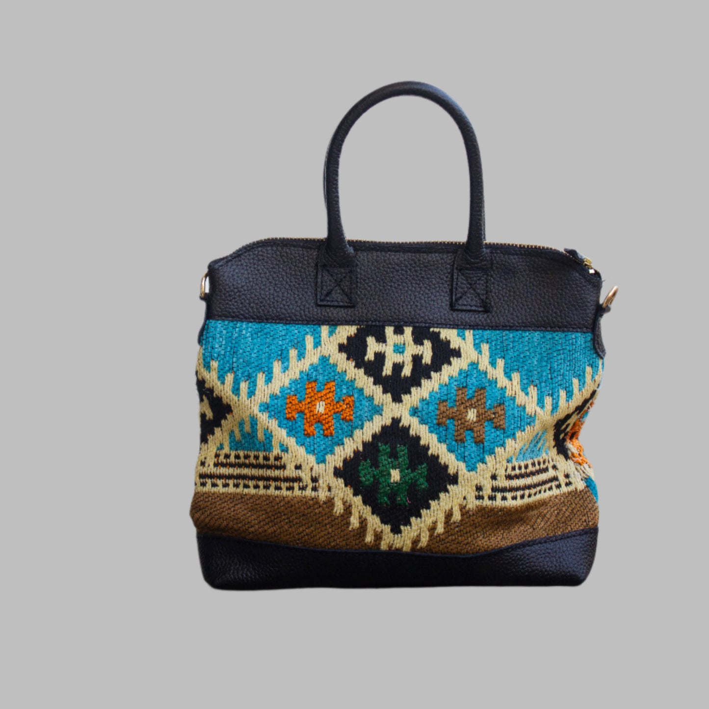 Weekend Kilim Genuine Leather Bag is Handcrafted in Old Cairo, Egypt, This bag is one of a kind masterpiece, made from vintage fabrics and genuine leather to embody the essence of sustainable luxury.a gift to the world of Ancient craftsmanship meeting modern functionality. A statement of creativity, cultural awareness and limitless style.