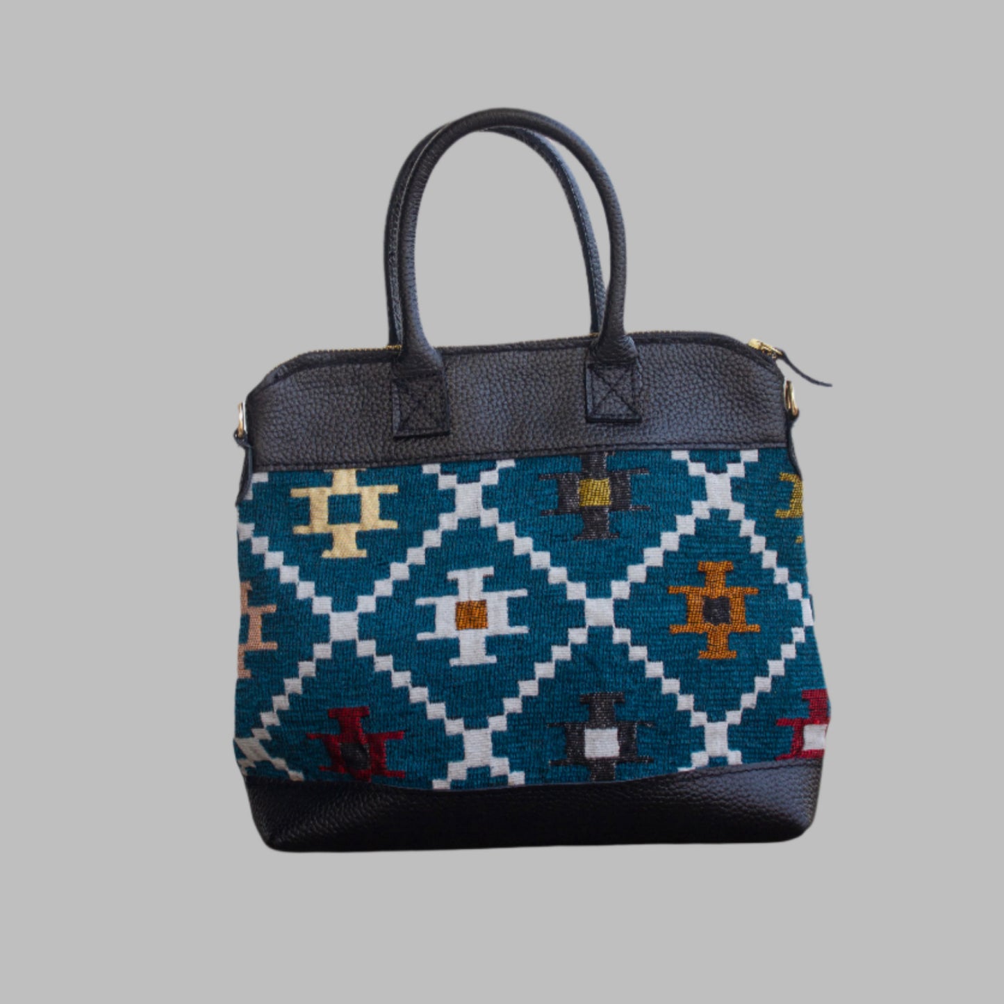 Weekend Kilim Genuine Leather Bag is Handcrafted in Old Cairo, Egypt, This bag is one of a kind masterpiece, made from vintage fabrics and genuine leather to embody the essence of sustainable luxury.a gift to the world of Ancient craftsmanship meeting modern functionality. A statement of creativity, cultural awareness and limitless style.