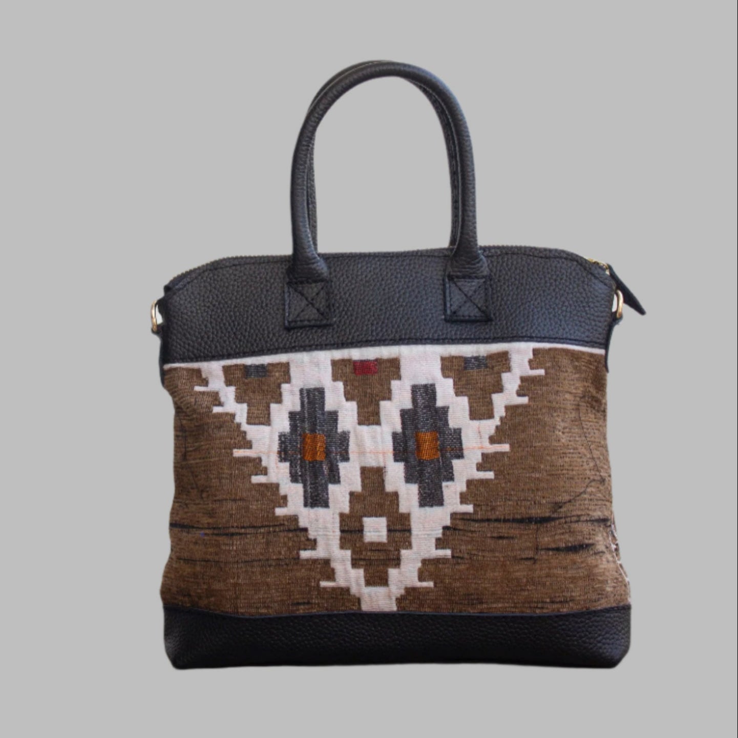 Weekend Kilim Genuine Leather Bag is Handcrafted in Old Cairo, Egypt, This bag is one of a kind masterpiece, made from vintage fabrics and genuine leather to embody the essence of sustainable luxury.a gift to the world of Ancient craftsmanship meeting modern functionality. A statement of creativity, cultural awareness and limitless style.