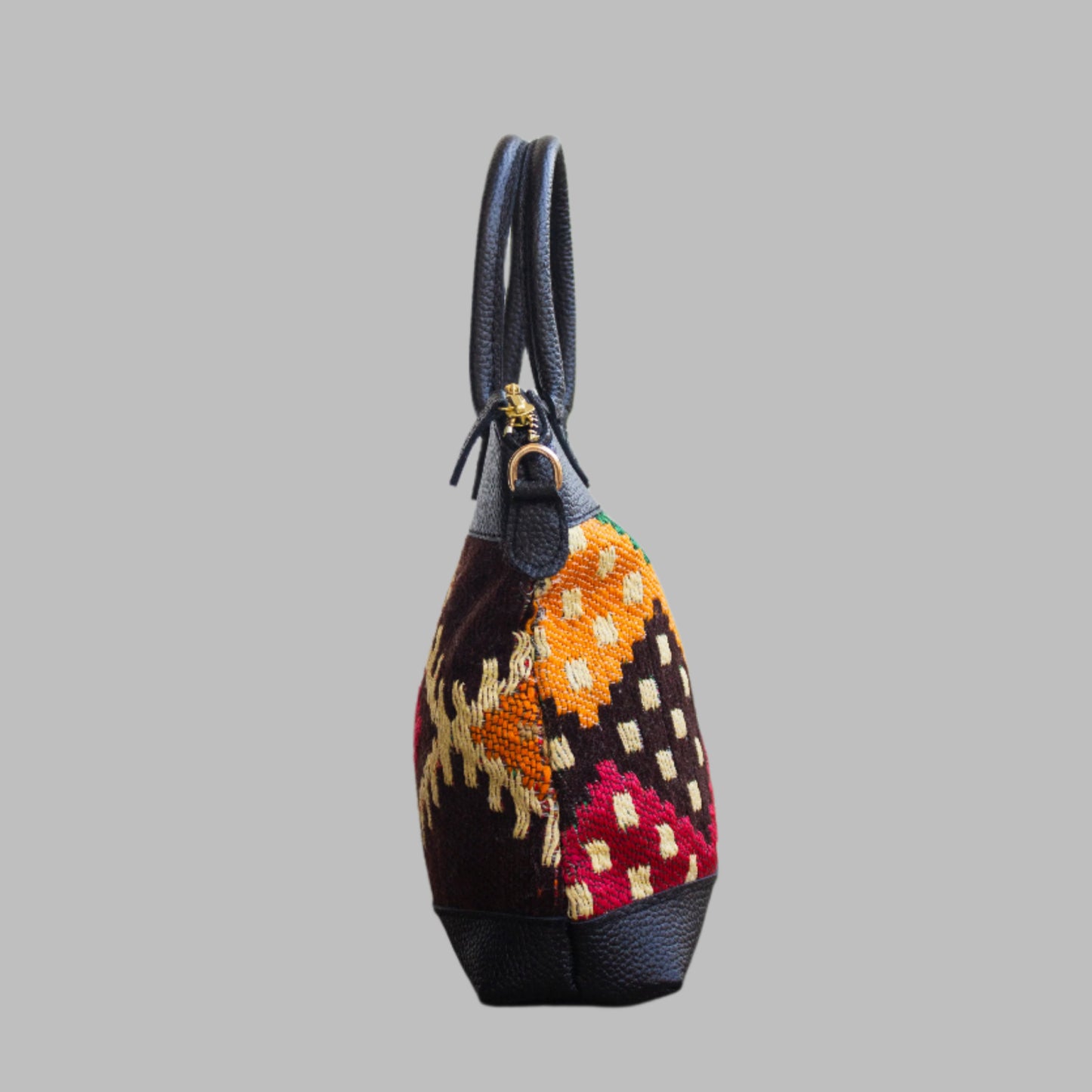 Weekend Kilim Genuine Leather Bag is Handcrafted in Old Cairo, Egypt, This bag is one of a kind masterpiece, made from vintage fabrics and genuine leather to embody the essence of sustainable luxury.a gift to the world of Ancient craftsmanship meeting modern functionality. A statement of creativity, cultural awareness and limitless style.