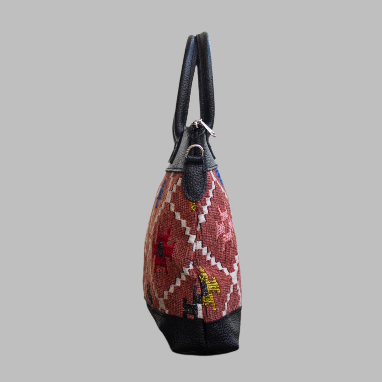 Weekend Kilim Genuine Leather Bag is Handcrafted in Old Cairo, Egypt, This bag is one of a kind masterpiece, made from vintage fabrics and genuine leather to embody the essence of sustainable luxury.a gift to the world of Ancient craftsmanship meeting modern functionality. A statement of creativity, cultural awareness and limitless style.