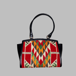 Elibelinde Kilim PU Leather Bag M size is Handcrafted in Old Cairo, Egypt, This bag is one of a kind  masterpiece, made from vintage fabrics and genuine leather to embody the essence of sustainable luxury.a gift to the world of Ancient craftsmanship meeting modern functionality. A statement of creativity, cultural awareness and limitless style.