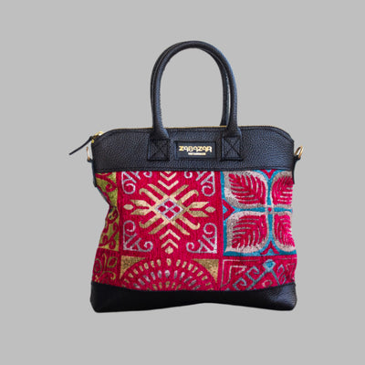 Weekend Kilim Genuine Leather Bag is Handcrafted in Old Cairo, Egypt, This bag is one of a kind  masterpiece, made from vintage fabrics and genuine leather to embody the essence of sustainable luxury.a gift to the world of Ancient craftsmanship meeting modern functionality. A statement of creativity, cultural awareness and limitless style.