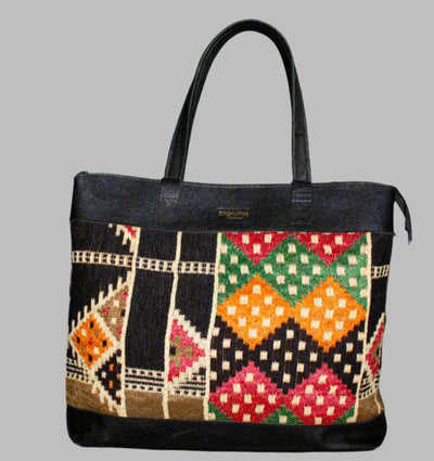 Weekend Kilim Genuine Leather Bag XL size is Handcrafted in Old Cairo, Egypt, This bag is one of a kind  masterpiece, made from vintage fabrics and genuine leather to embody the essence of sustainable luxury.a gift to the world of Ancient craftsmanship meeting modern functionality. A statement of creativity, cultural awareness and limitless style.