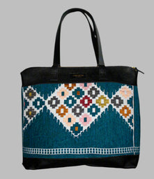 Weekend Kilim Genuine Leather Bag XL size is Handcrafted in Old Cairo, Egypt, This bag is one of a kind  masterpiece, made from vintage fabrics and genuine leather to embody the essence of sustainable luxury.a gift to the world of Ancient craftsmanship meeting modern functionality. A statement of creativity, cultural awareness and limitless style.