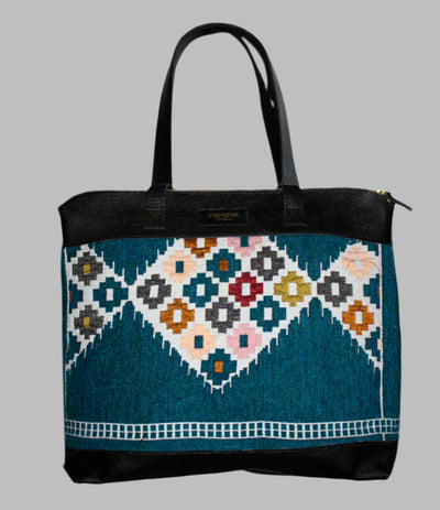 Weekend Kilim Genuine Leather Bag XL size is Handcrafted in Old Cairo, Egypt, This bag is one of a kind  masterpiece, made from vintage fabrics and genuine leather to embody the essence of sustainable luxury.a gift to the world of Ancient craftsmanship meeting modern functionality. A statement of creativity, cultural awareness and limitless style.
