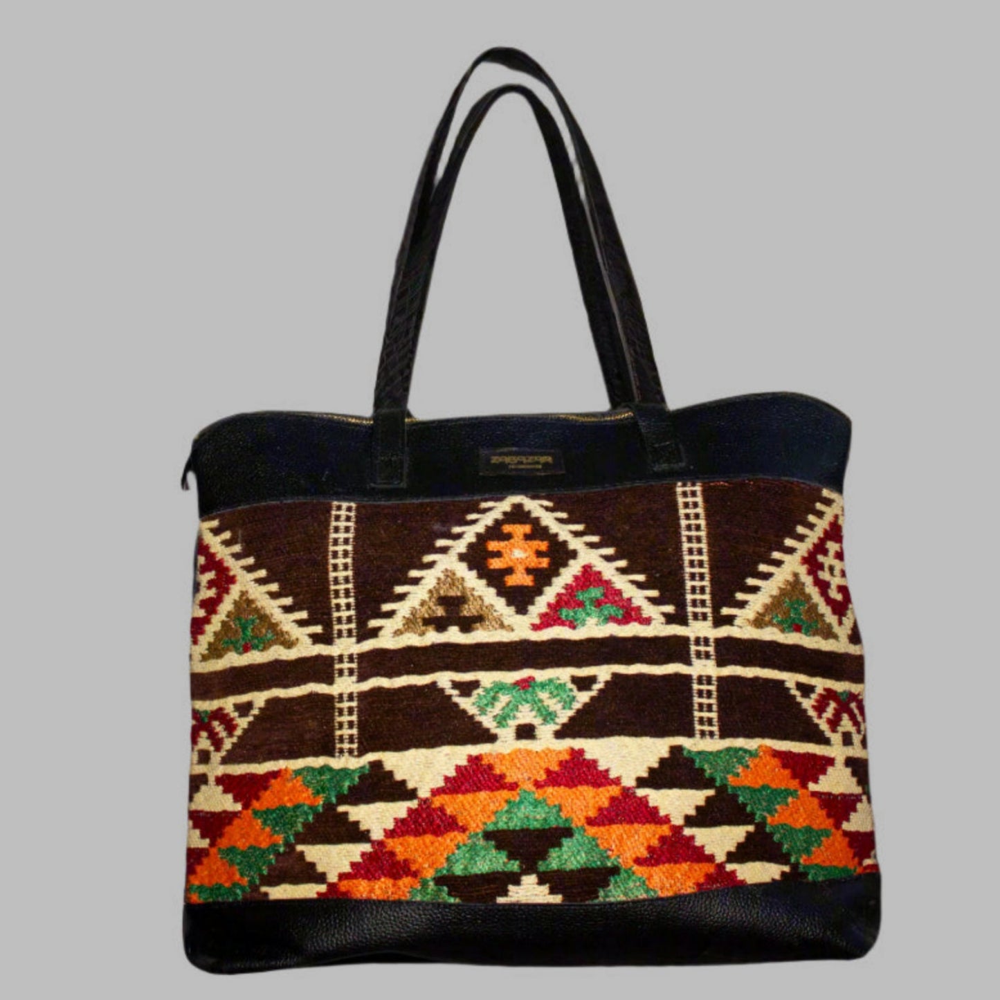 Weekend Kilim Genuine Leather Bag XL size is Handcrafted in Old Cairo, Egypt, This bag is one of a kind  masterpiece, made from vintage fabrics and genuine leather to embody the essence of sustainable luxury.a gift to the world of Ancient craftsmanship meeting modern functionality. A statement of creativity, cultural awareness and limitless style.