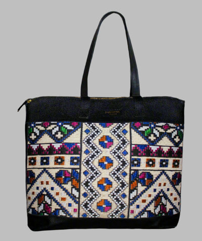 Weekend Kilim Genuine Leather Bag XL size is Handcrafted in Old Cairo, Egypt, This bag is one of a kind  masterpiece, made from vintage fabrics and genuine leather to embody the essence of sustainable luxury.a gift to the world of Ancient craftsmanship meeting modern functionality. A statement of creativity, cultural awareness and limitless style.