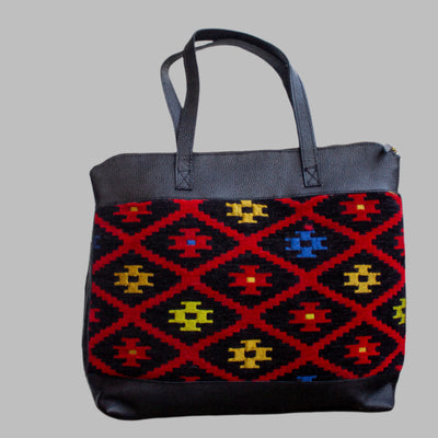 Weekend Kilim Genuine Leather Bag XL size is Handcrafted in Old Cairo, Egypt, This bag is one of a kind  masterpiece, made from vintage fabrics and genuine leather to embody the essence of sustainable luxury.a gift to the world of Ancient craftsmanship meeting modern functionality. A statement of creativity, cultural awareness and limitless style.