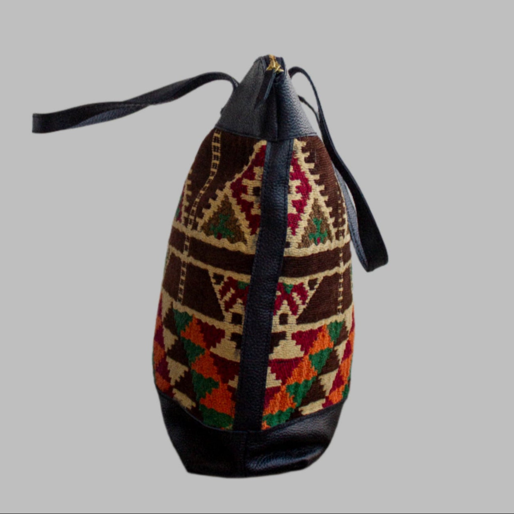 Weekend Kilim Genuine Leather Bag XL size is Handcrafted in Old Cairo, Egypt, This bag is one of a kind  masterpiece, made from vintage fabrics and genuine leather to embody the essence of sustainable luxury.a gift to the world of Ancient craftsmanship meeting modern functionality. A statement of creativity, cultural awareness and limitless style.