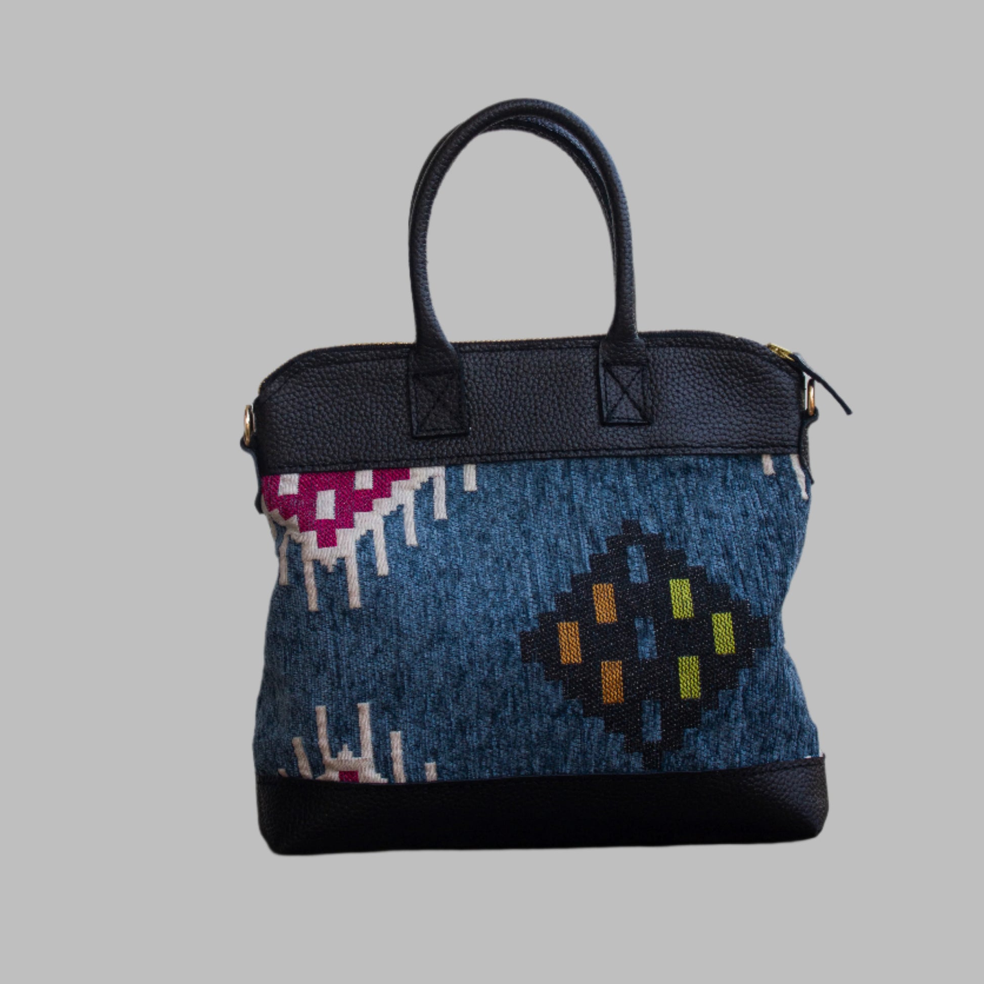 Weekend Kilim Genuine Leather Bag is Handcrafted in Old Cairo, Egypt, This bag is one of a kind  masterpiece, made from vintage fabrics and genuine leather to embody the essence of sustainable luxury.a gift to the world of Ancient craftsmanship meeting modern functionality. A statement of creativity, cultural awareness and limitless style.