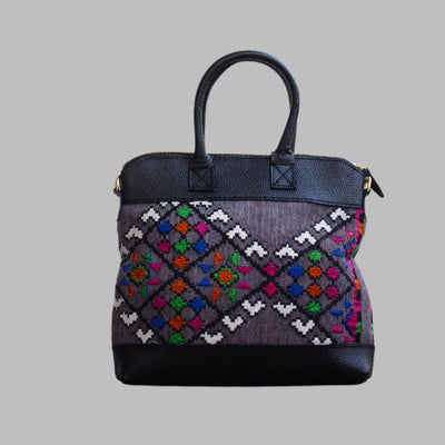 Weekend Kilim Genuine Leather Bag is Handcrafted in Old Cairo, Egypt, This bag is one of a kind  masterpiece, made from vintage fabrics and genuine leather to embody the essence of sustainable luxury.a gift to the world of Ancient craftsmanship meeting modern functionality. A statement of creativity, cultural awareness and limitless style.