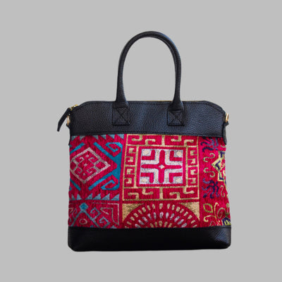 Weekend Kilim Genuine Leather Bag is Handcrafted in Old Cairo, Egypt, This bag is one of a kind  masterpiece, made from vintage fabrics and genuine leather to embody the essence of sustainable luxury.a gift to the world of Ancient craftsmanship meeting modern functionality. A statement of creativity, cultural awareness and limitless style.