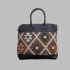 Weekend Kilim Genuine Leather Bag is Handcrafted in Old Cairo, Egypt, This bag is one of a kind  masterpiece, made from vintage fabrics and genuine leather to embody the essence of sustainable luxury.a gift to the world of Ancient craftsmanship meeting modern functionality. A statement of creativity, cultural awareness and limitless style.