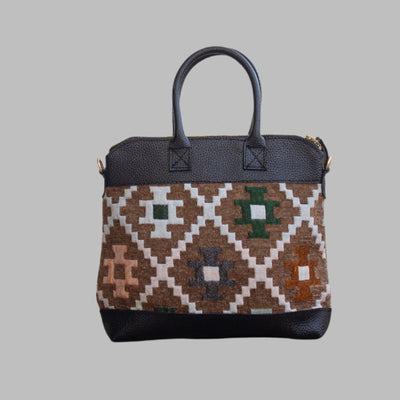 Weekend Kilim Genuine Leather Bag is Handcrafted in Old Cairo, Egypt, This bag is one of a kind  masterpiece, made from vintage fabrics and genuine leather to embody the essence of sustainable luxury.a gift to the world of Ancient craftsmanship meeting modern functionality. A statement of creativity, cultural awareness and limitless style.