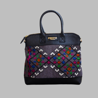 Weekend Kilim Genuine Leather Bag is Handcrafted in Old Cairo, Egypt, This bag is one of a kind  masterpiece, made from vintage fabrics and genuine leather to embody the essence of sustainable luxury.a gift to the world of Ancient craftsmanship meeting modern functionality. A statement of creativity, cultural awareness and limitless style.