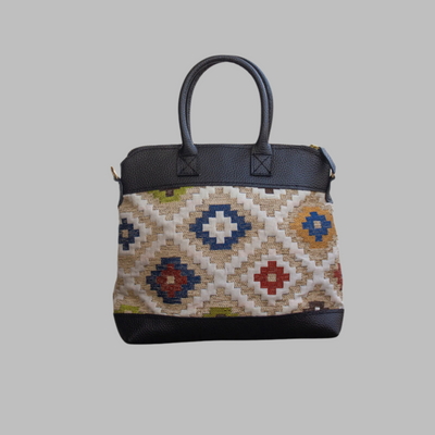 Weekend Kilim Genuine Leather Bag is Handcrafted in Old Cairo, Egypt, This bag is one of a kind  masterpiece, made from vintage fabrics and genuine leather to embody the essence of sustainable luxury.a gift to the world of Ancient craftsmanship meeting modern functionality. A statement of creativity, cultural awareness and limitless style.