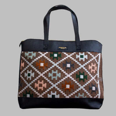 Weekend Kilim Genuine Leather Bag XL size is Handcrafted in Old Cairo, Egypt, This bag is one of a kind  masterpiece, made from vintage fabrics and genuine leather to embody the essence of sustainable luxury.a gift to the world of Ancient craftsmanship meeting modern functionality. A statement of creativity, cultural awareness and limitless style.