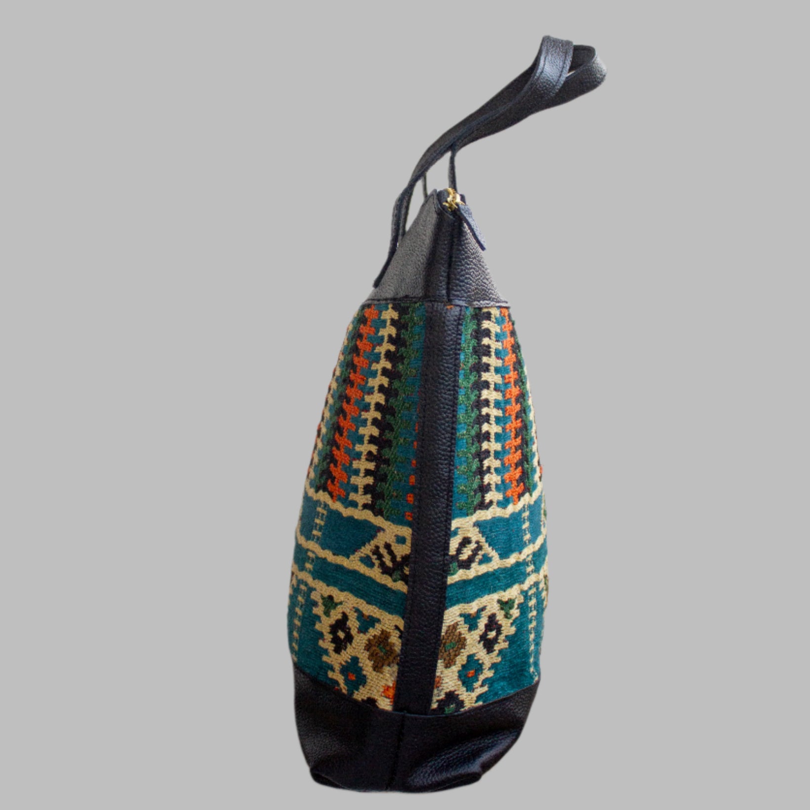 Weekend Kilim Genuine Leather Bag XL size is Handcrafted in Old Cairo, Egypt, This bag is one of a kind  masterpiece, made from vintage fabrics and genuine leather to embody the essence of sustainable luxury.a gift to the world of Ancient craftsmanship meeting modern functionality. A statement of creativity, cultural awareness and limitless style.