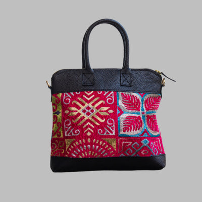 Weekend Kilim Genuine Leather Bag is Handcrafted in Old Cairo, Egypt, This bag is one of a kind  masterpiece, made from vintage fabrics and genuine leather to embody the essence of sustainable luxury.a gift to the world of Ancient craftsmanship meeting modern functionality. A statement of creativity, cultural awareness and limitless style.