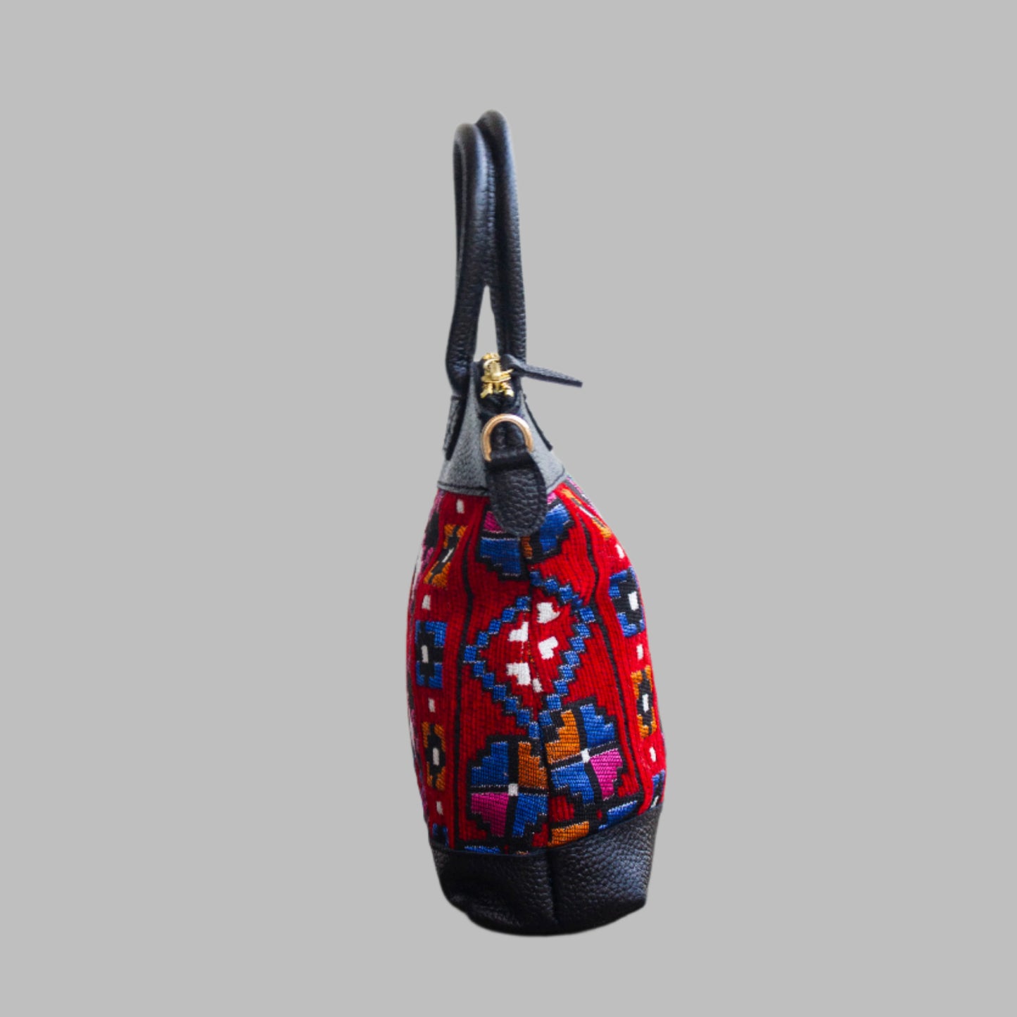 Weekend Kilim Genuine Leather Bag is Handcrafted in Old Cairo, Egypt, This bag is one of a kind  masterpiece, made from vintage fabrics and genuine leather to embody the essence of sustainable luxury.a gift to the world of Ancient craftsmanship meeting modern functionality. A statement of creativity, cultural awareness and limitless style.