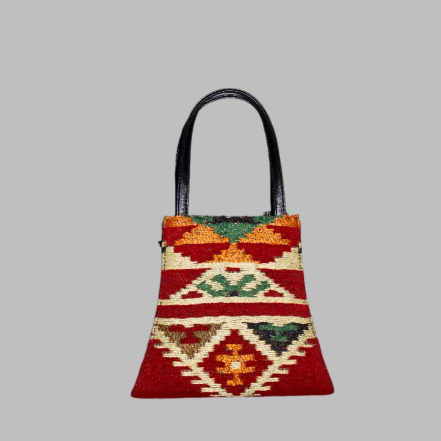 Elibelinde Kilim PU Leather Bag S size is Handcrafted in Old Cairo, Egypt, This bag is one of a kind  masterpiece, made from vintage fabrics and genuine leather to embody the essence of sustainable luxury.a gift to the world of Ancient craftsmanship meeting modern functionality. A statement of creativity, cultural awareness and limitless style.