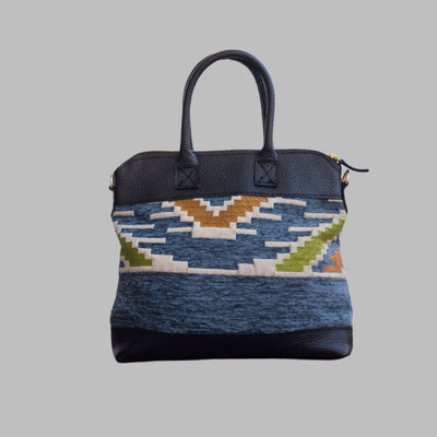 Weekend Kilim Genuine Leather Bag is Handcrafted in Old Cairo, Egypt, This bag is one of a kind  masterpiece, made from vintage fabrics and genuine leather to embody the essence of sustainable luxury.a gift to the world of Ancient craftsmanship meeting modern functionality. A statement of creativity, cultural awareness and limitless style.