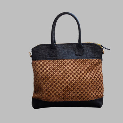 Weekend Kilim Genuine Leather Bag is Handcrafted in Old Cairo, Egypt, This bag is one of a kind  masterpiece, made from vintage fabrics and genuine leather to embody the essence of sustainable luxury.a gift to the world of Ancient craftsmanship meeting modern functionality. A statement of creativity, cultural awareness and limitless style.