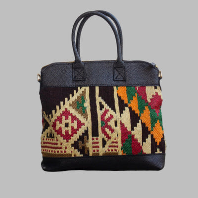 Weekend Kilim Genuine Leather Bag is Handcrafted in Old Cairo, Egypt, This bag is one of a kind  masterpiece, made from vintage fabrics and genuine leather to embody the essence of sustainable luxury.a gift to the world of Ancient craftsmanship meeting modern functionality. A statement of creativity, cultural awareness and limitless style.