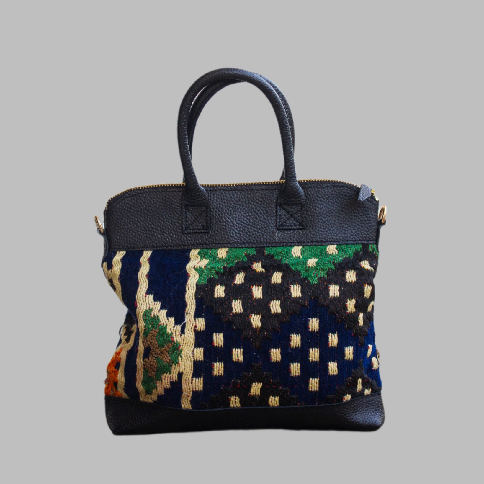 Weekend Kilim Genuine Leather Bag is Handcrafted in Old Cairo, Egypt, This bag is one of a kind  masterpiece, made from vintage fabrics and genuine leather to embody the essence of sustainable luxury.a gift to the world of Ancient craftsmanship meeting modern functionality. A statement of creativity, cultural awareness and limitless style.