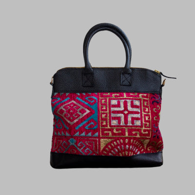 Weekend Kilim Genuine Leather Bag is Handcrafted in Old Cairo, Egypt, This bag is one of a kind  masterpiece, made from vintage fabrics and genuine leather to embody the essence of sustainable luxury.a gift to the world of Ancient craftsmanship meeting modern functionality. A statement of creativity, cultural awareness and limitless style.