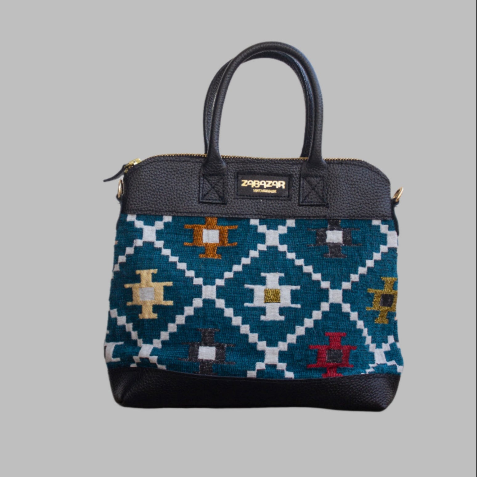 Weekend Kilim Genuine Leather Bag is Handcrafted in Old Cairo, Egypt, This bag is one of a kind  masterpiece, made from vintage fabrics and genuine leather to embody the essence of sustainable luxury.a gift to the world of Ancient craftsmanship meeting modern functionality. A statement of creativity, cultural awareness and limitless style.