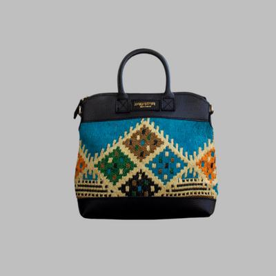 Weekend Kilim Genuine Leather Bag is Handcrafted in Old Cairo, Egypt, This bag is one of a kind  masterpiece, made from vintage fabrics and genuine leather to embody the essence of sustainable luxury.a gift to the world of Ancient craftsmanship meeting modern functionality. A statement of creativity, cultural awareness and limitless style.