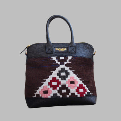 Weekend Kilim Genuine Leather Bag is Handcrafted in Old Cairo, Egypt, This bag is one of a kind  masterpiece, made from vintage fabrics and genuine leather to embody the essence of sustainable luxury.a gift to the world of Ancient craftsmanship meeting modern functionality. A statement of creativity, cultural awareness and limitless style.