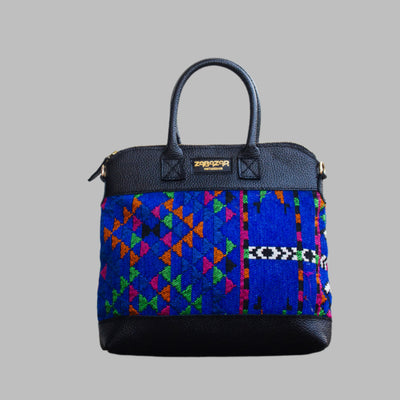 Weekend Kilim Genuine Leather Bag is Handcrafted in Old Cairo, Egypt, This bag is one of a kind  masterpiece, made from vintage fabrics and genuine leather to embody the essence of sustainable luxury.a gift to the world of Ancient craftsmanship meeting modern functionality. A statement of creativity, cultural awareness and limitless style.