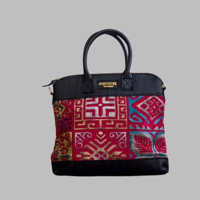Weekend Kilim Genuine Leather Bag is Handcrafted in Old Cairo, Egypt, This bag is one of a kind  masterpiece, made from vintage fabrics and genuine leather to embody the essence of sustainable luxury.a gift to the world of Ancient craftsmanship meeting modern functionality. A statement of creativity, cultural awareness and limitless style.